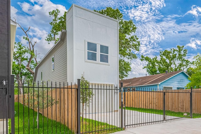 7307 W Knoll St, Houston, TX 77028 - view of property exterior featuring a fenced front yard, stucco siding, and a gate