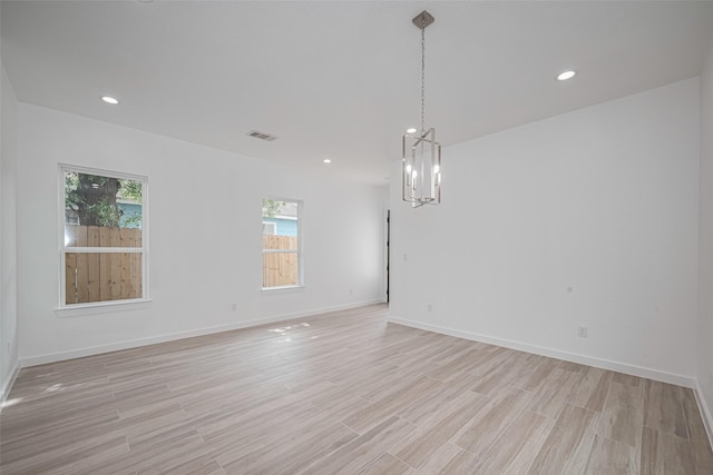 7307 W Knoll St, Houston, TX 77028 - empty room with an inviting chandelier, light wood-style flooring, baseboards, and recessed lighting