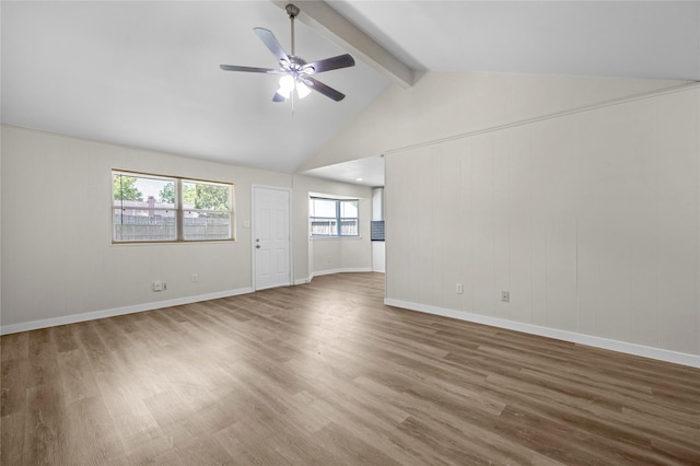 6727 Winding Trace Dr, Houston, TX 77086 - unfurnished living room featuring wood finished floors, beamed ceiling, a ceiling fan, baseboards, and high vaulted ceiling