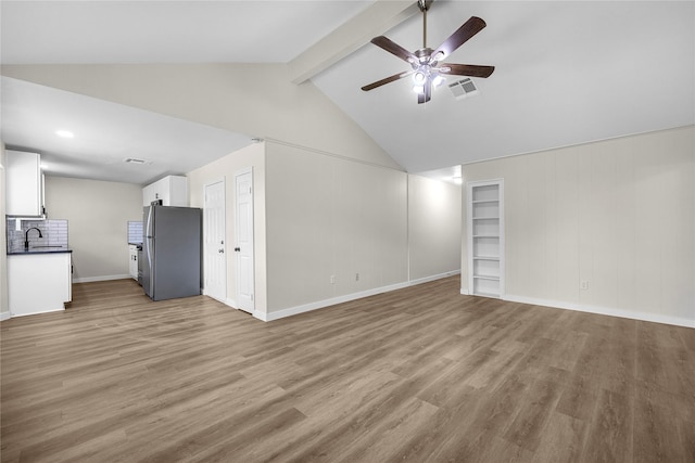 6727 Winding Trace Dr, Houston, TX 77086 - unfurnished living room featuring ceiling fan, light wood-style floors, a sink, and baseboards