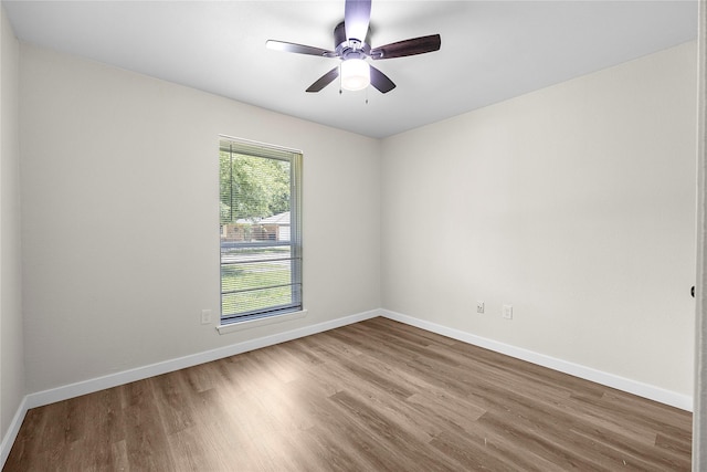 6727 Winding Trace Dr, Houston, TX 77086 - unfurnished room with wood finished floors, baseboards, and a ceiling fan