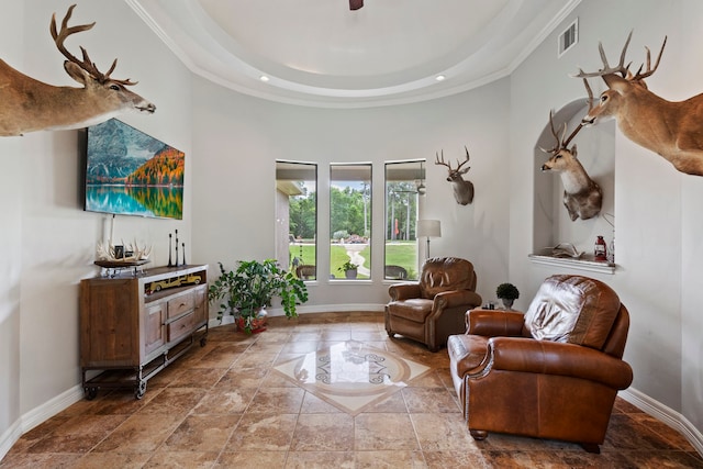 8483 Majestic Lake Ct, Montgomery, TX 77316 - sitting room with stone tile flooring, ornamental molding, a towering ceiling, visible vents, and baseboards