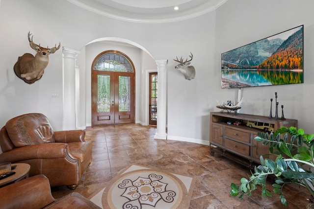 8483 Majestic Lake Ct, Montgomery, TX 77316 - entrance foyer featuring a towering ceiling, ornate columns, crown molding, arched walkways, and baseboards
