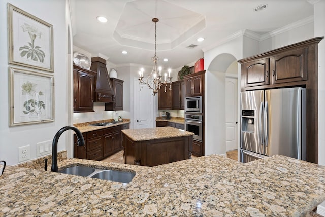 8483 Majestic Lake Ct, Montgomery, TX 77316 - kitchen featuring dark brown cabinets, a sink, stainless steel appliances, light stone countertops, and a kitchen island
