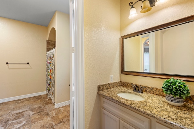 8483 Majestic Lake Ct, Montgomery, TX 77316 - bathroom featuring a shower with shower curtain, baseboards, vanity, and stone finish floor
