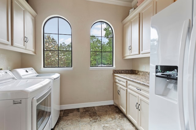 8483 Majestic Lake Ct, Montgomery, TX 77316 - clothes washing area featuring washing machine and dryer, a wealth of natural light, cabinet space, and baseboards