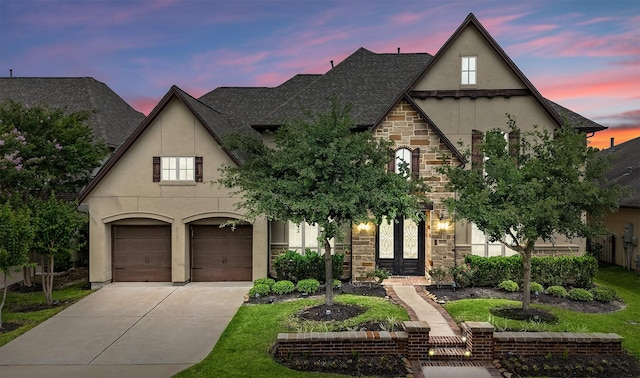 18538 Wade Creek Ln, Cypress, TX 77433 - french country home featuring stone siding, stucco siding, driveway, and an attached garage