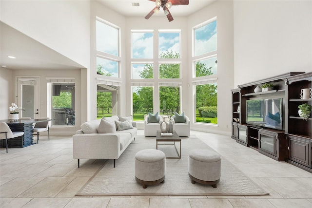 18538 Wade Creek Ln, Cypress, TX 77433 - living area featuring a high ceiling, a ceiling fan, and a healthy amount of sunlight