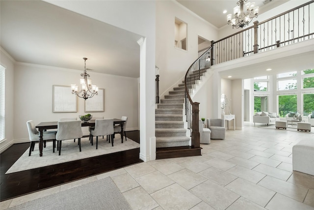 18538 Wade Creek Ln, Cypress, TX 77433 - tiled foyer featuring stairway, an inviting chandelier, a wealth of natural light, and crown molding