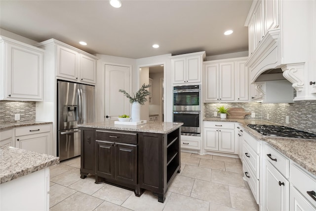 18538 Wade Creek Ln, Cypress, TX 77433 - kitchen with stainless steel appliances, decorative backsplash, light stone counters, and white cabinets