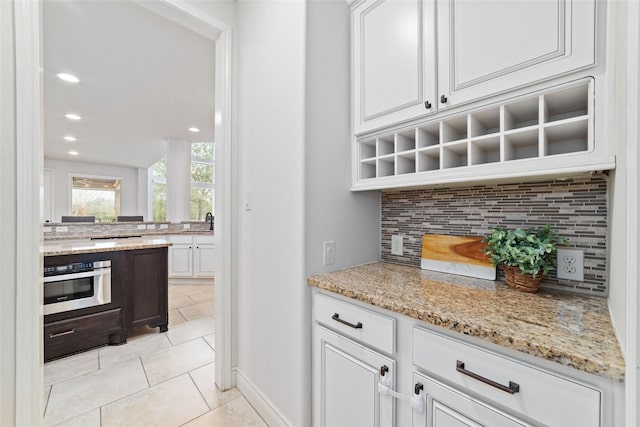 18538 Wade Creek Ln, Cypress, TX 77433 - bar with recessed lighting, light tile patterned flooring, stainless steel oven, and backsplash