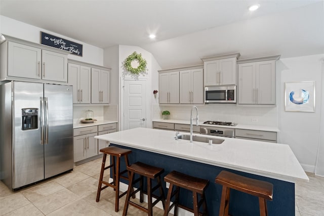 18740 Laurel Hills Dr, New Caney, TX 77357 - kitchen featuring stainless steel appliances, a sink, decorative backsplash, and vaulted ceiling