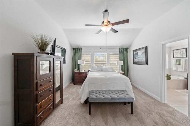 18740 Laurel Hills Dr, New Caney, TX 77357 - bedroom with ensuite bath, vaulted ceiling, ceiling fan, light carpet, and baseboards
