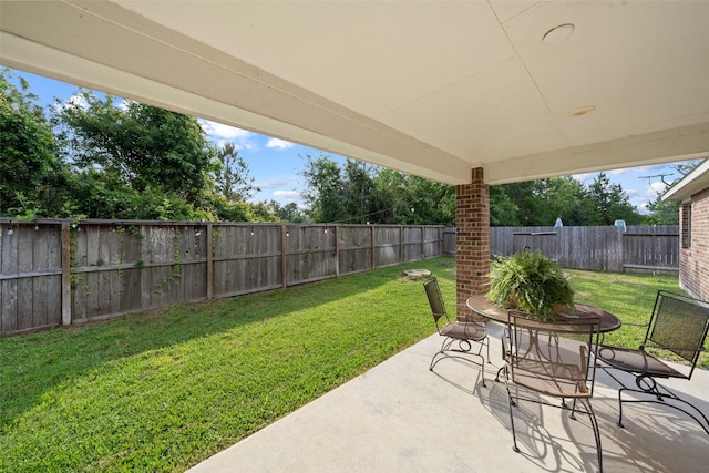 18740 Laurel Hills Dr, New Caney, TX 77357 - view of patio featuring outdoor dining space and a fenced backyard