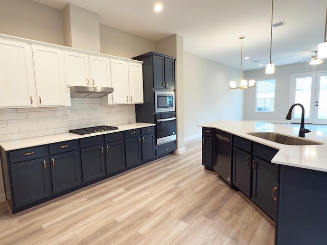 313 E 27th St, Houston, TX 77008 - kitchen with dishwashing machine, a sink, oven, stainless steel microwave, and under cabinet range hood
