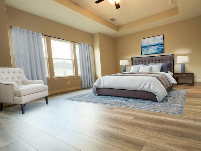 313 E 27th St, Houston, TX 77008 - bedroom with ceiling fan, a raised ceiling, baseboards, and wood finished floors