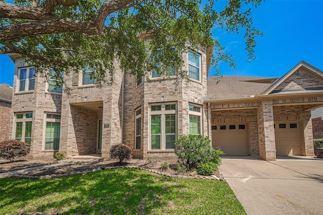 7611 Herndon Pl, Sugar Land, TX 77479 - view of front facade with brick siding, a garage, concrete driveway, and a front lawn