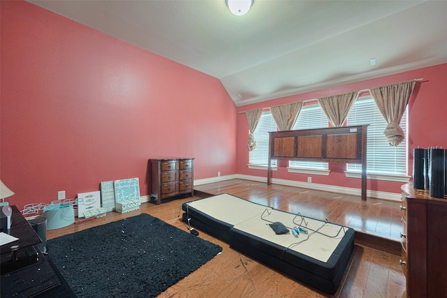 7611 Herndon Pl, Sugar Land, TX 77479 - living area with wood-type flooring, baseboards, and vaulted ceiling