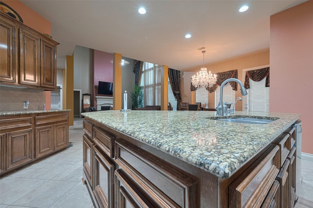 7611 Herndon Pl, Sugar Land, TX 77479 - kitchen featuring a sink, a chandelier, light stone countertops, recessed lighting, and tasteful backsplash