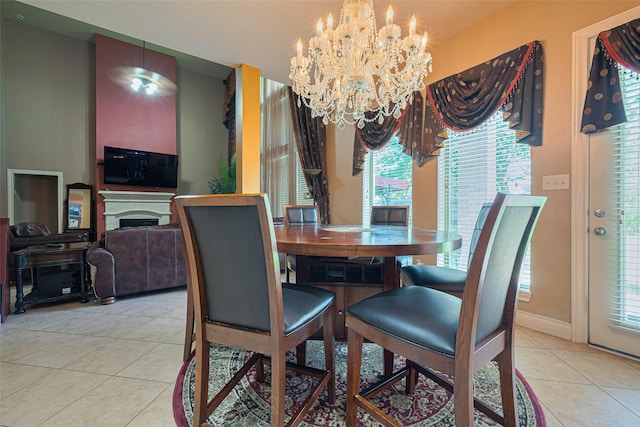 7611 Herndon Pl, Sugar Land, TX 77479 - tiled dining space featuring a chandelier, a fireplace, and baseboards