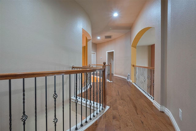 7611 Herndon Pl, Sugar Land, TX 77479 - corridor with arched walkways, wood finished floors, recessed lighting, and baseboards