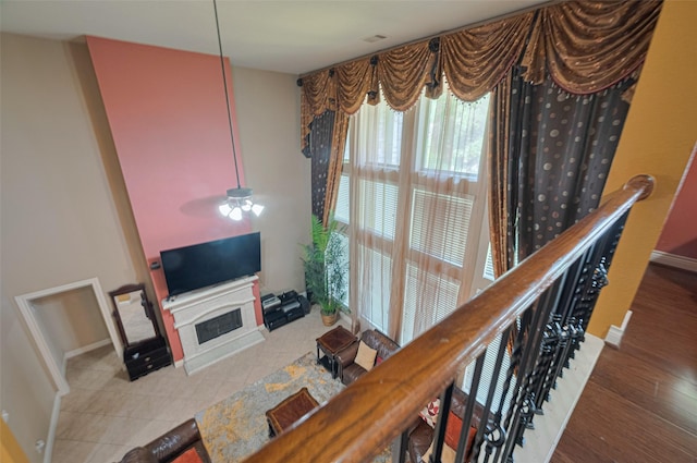 7611 Herndon Pl, Sugar Land, TX 77479 - living area with baseboards, a fireplace with raised hearth, ceiling fan, and wood finished floors