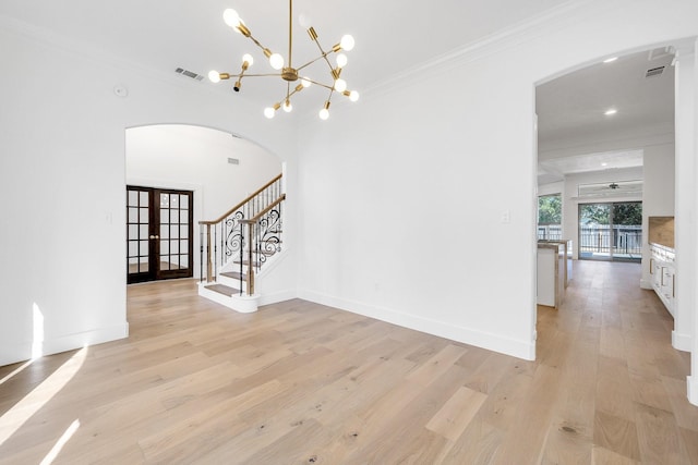686 Edgewood Dr, Montgomery, TX 77356 - interior space with french doors, light wood finished floors, stairs, crown molding, and arched walkways