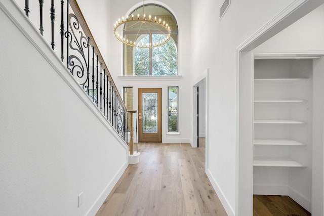 686 Edgewood Dr, Montgomery, TX 77356 - foyer entrance with a chandelier, light wood-style flooring, stairs, and baseboards