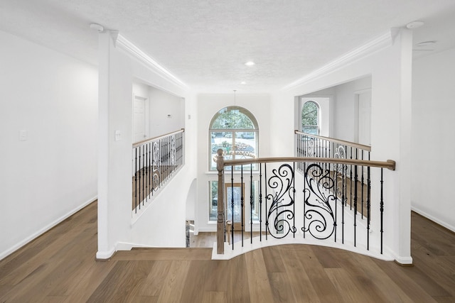 686 Edgewood Dr, Montgomery, TX 77356 - staircase with crown molding, wood finished floors, and baseboards