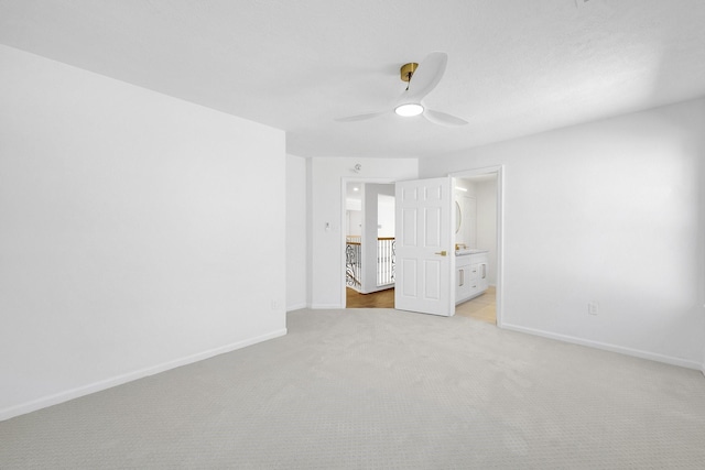 686 Edgewood Dr, Montgomery, TX 77356 - unfurnished bedroom with baseboards, ensuite bathroom, light carpet, and ceiling fan