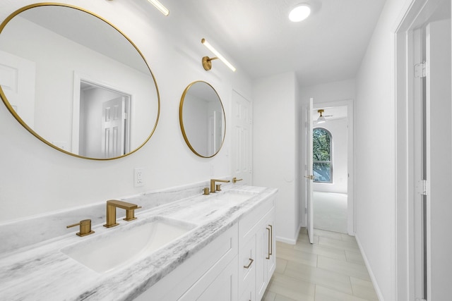 686 Edgewood Dr, Montgomery, TX 77356 - bathroom featuring a sink, double vanity, and baseboards