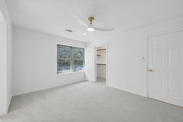 686 Edgewood Dr, Montgomery, TX 77356 - unfurnished bedroom featuring carpet, visible vents, a ceiling fan, a walk in closet, and baseboards
