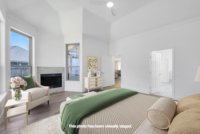686 Edgewood Dr, Montgomery, TX 77356 - bedroom with a high end fireplace, baseboards, high vaulted ceiling, and wood finished floors