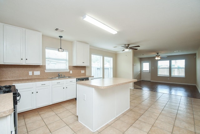 19826 Seagler Glen Ln, Katy, TX 77449 - kitchen featuring a sink, gas range, light tile patterned floors, light countertops, and plenty of natural light