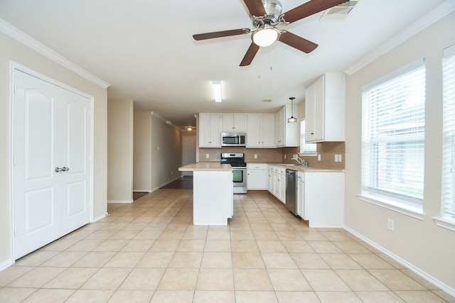 19826 Seagler Glen Ln, Katy, TX 77449 - kitchen with appliances with stainless steel finishes, decorative backsplash, a sink, light countertops, and light tile patterned floors