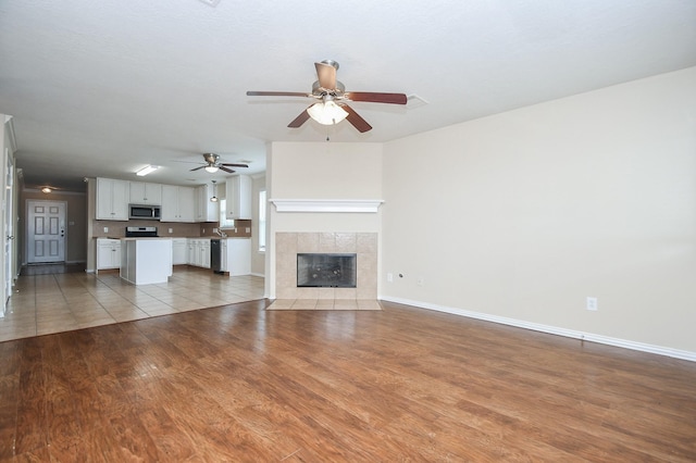 19826 Seagler Glen Ln, Katy, TX 77449 - unfurnished living room with ceiling fan, light wood-style flooring, and baseboards