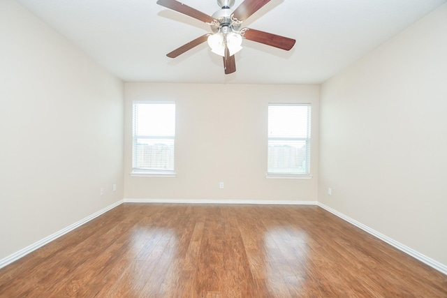 19826 Seagler Glen Ln, Katy, TX 77449 - empty room with healthy amount of natural light, wood finished floors, baseboards, and a ceiling fan