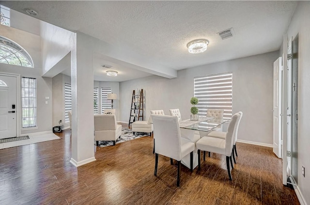16107 Lakestone Dr, Tomball, TX 77377 - dining space with wood finished floors, a textured ceiling, and baseboards
