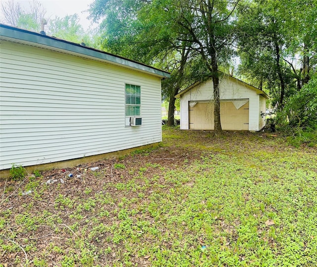 view of side of home with an outdoor structure and a detached garage
