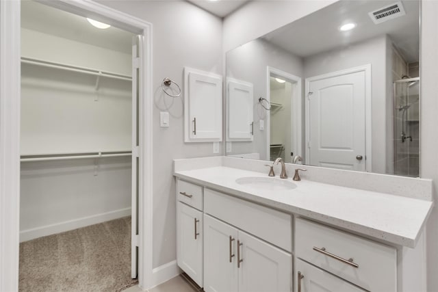 5432 Nolda St, Houston, TX 77007 - bathroom with baseboards, a shower with shower door, visible vents, vanity, and a spacious closet