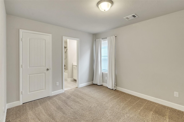 5432 Nolda St, Houston, TX 77007 - unfurnished bedroom with connected bathroom, carpet floors, baseboards, and visible vents
