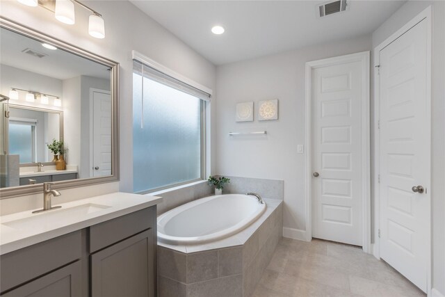 318 Mistletoe Ridge Ct, Montgomery, TX 77316 - full bathroom featuring tile patterned floors, vanity, visible vents, and a bath