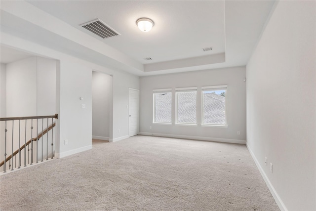 318 Mistletoe Ridge Ct, Montgomery, TX 77316 - carpeted spare room with a tray ceiling, baseboards, and visible vents