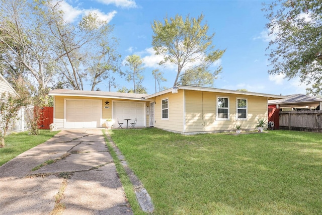ranch-style house featuring concrete driveway, a garage, fence, and a front yard