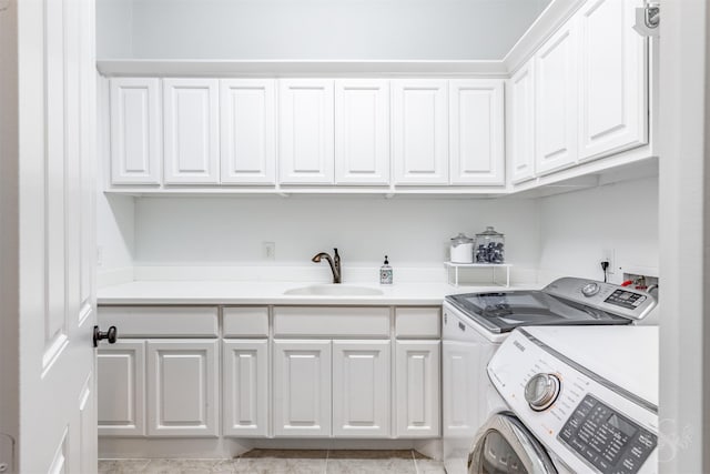 clothes washing area featuring cabinet space and washer and dryer