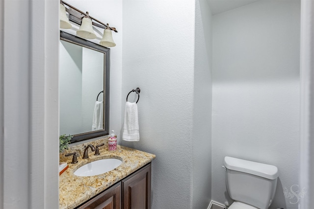 bathroom featuring toilet and vanity