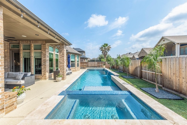 view of swimming pool with a fenced backyard, a patio area, and a pool with connected hot tub