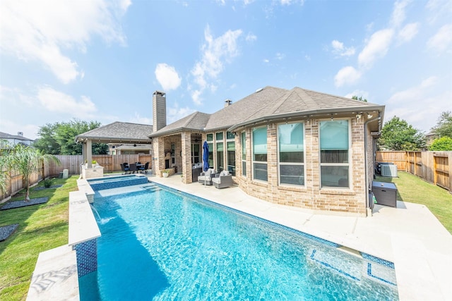 view of swimming pool featuring an outdoor hangout area, a patio, a fenced backyard, central AC unit, and a pool with connected hot tub