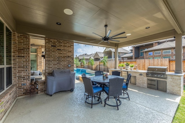 view of patio / terrace featuring exterior kitchen, area for grilling, and a fenced backyard