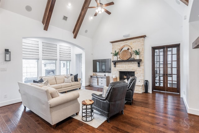 living room featuring high vaulted ceiling, dark wood-type flooring, baseboards, beamed ceiling, and a ceiling fan